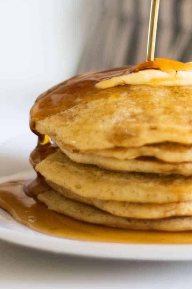 fluffy pancakes dripping with syrup and butter