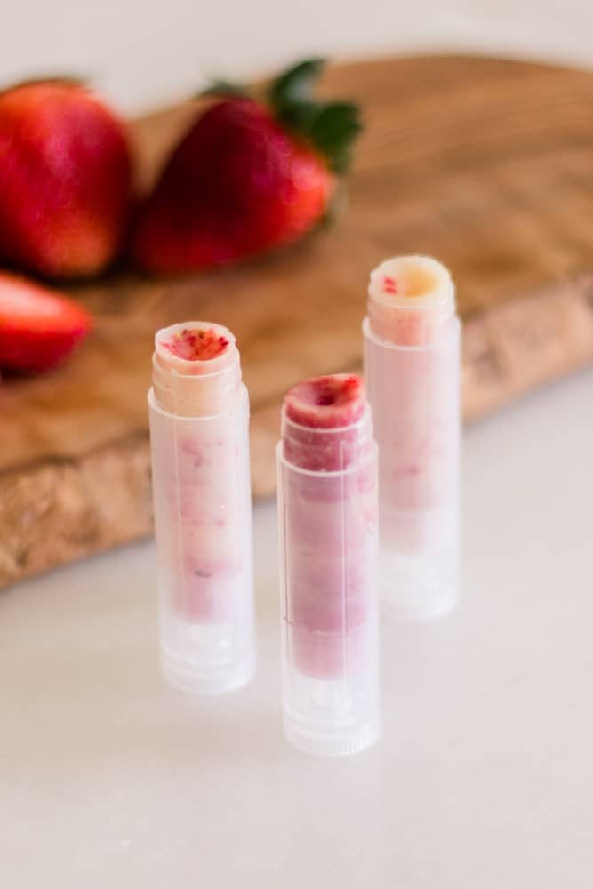 Homemade strawberry infused chapstick in plastic tubes.