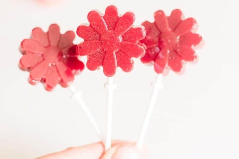 Three red strawberry lollipops.