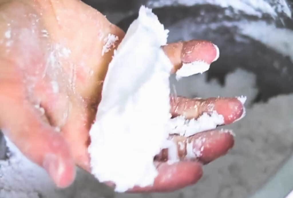 Testing the consistency of the toilet cleaning bombs with our hands.