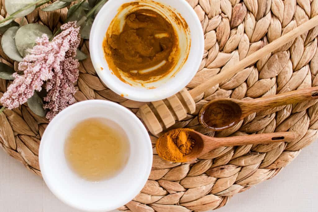 A homemade under eye mask with measuring spoons and dried flowers.