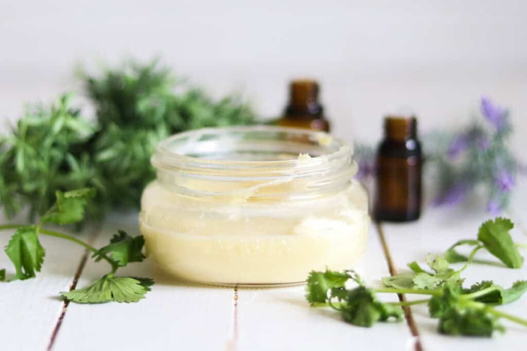 Whipped body butter recipe in a glass storage jar.