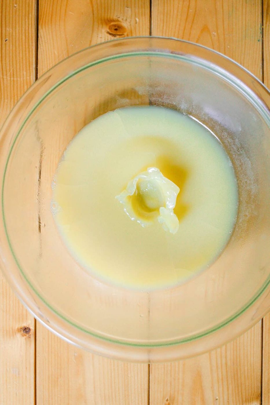 A bowl of chilled body butter with a finger print in it to show the consistency.