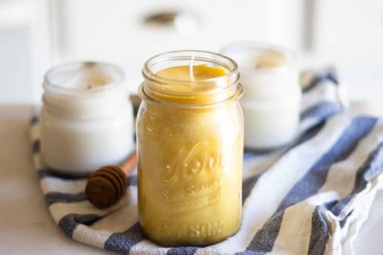 Homemade beeswax candles in mason jars.