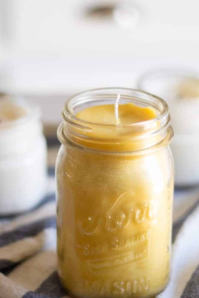 Homemade beeswax candle in a medium size mason jar.