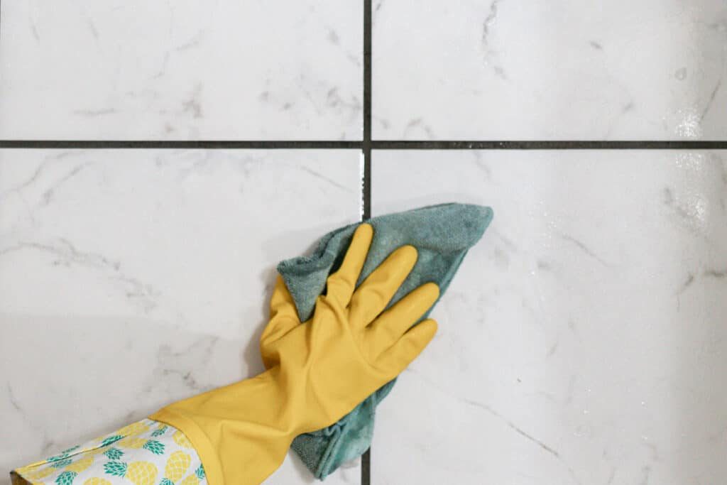 Wiping the surface clean with an old rag.