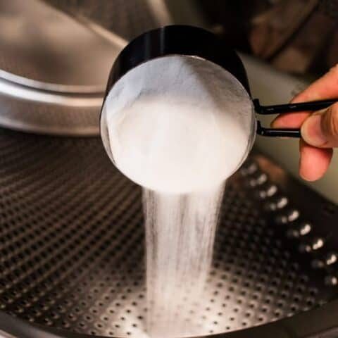 Adding baking soda to the drum of a front loader washer.