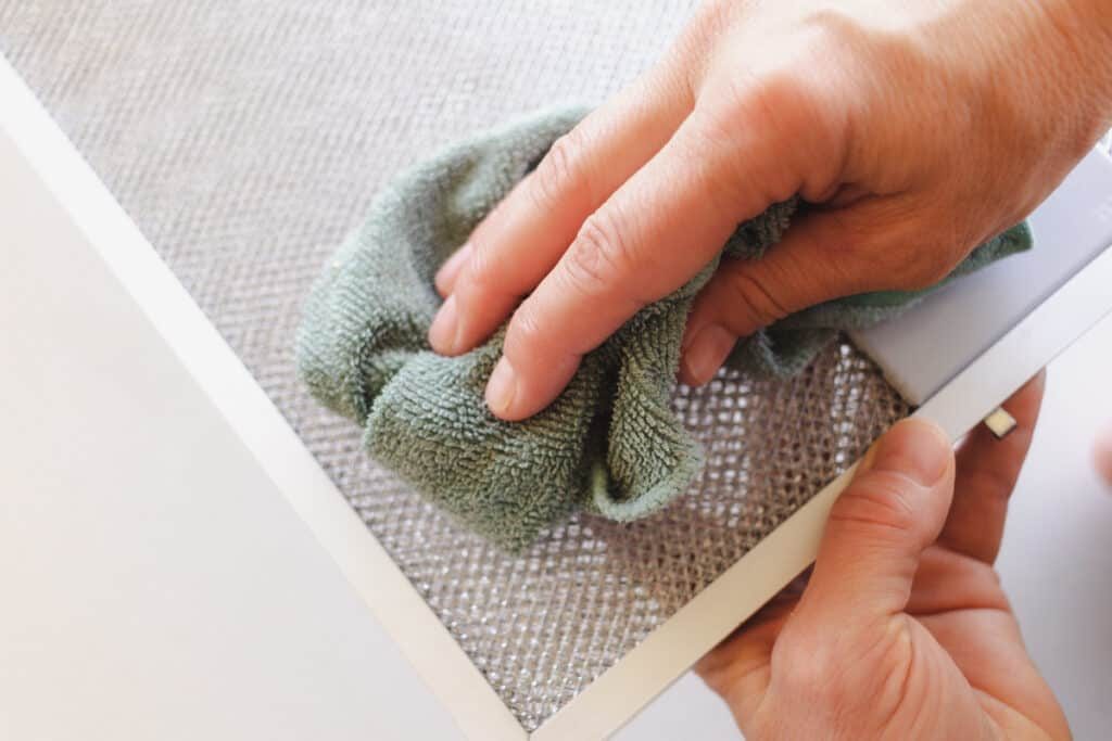 Cleaning a range hood filter.