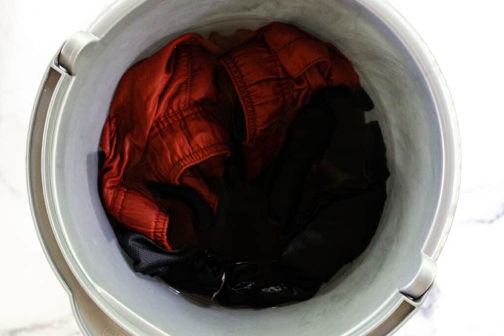 Soaking workout gear in a vinegar/water solution.