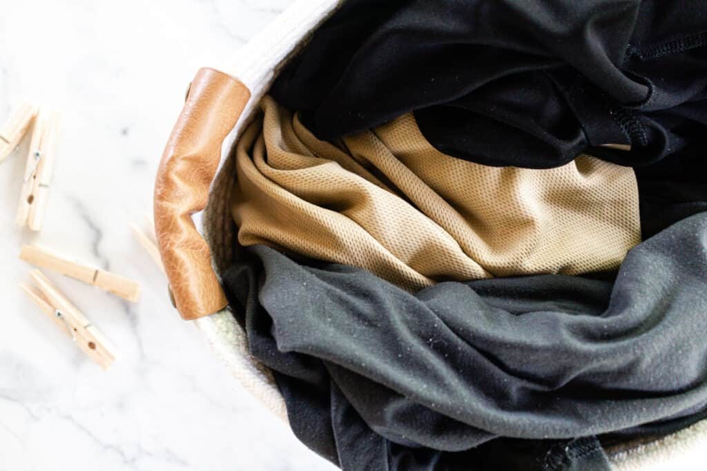 Smelly workout clothes in a hamper.