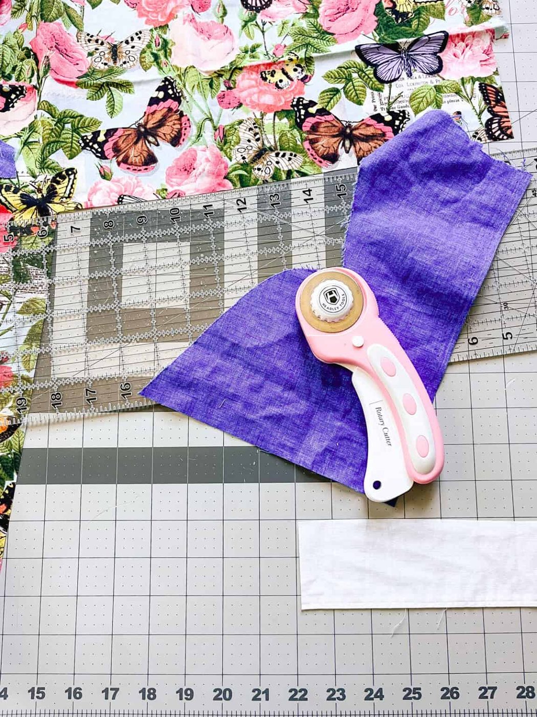 Cutting fabric with a rotary cutter.
