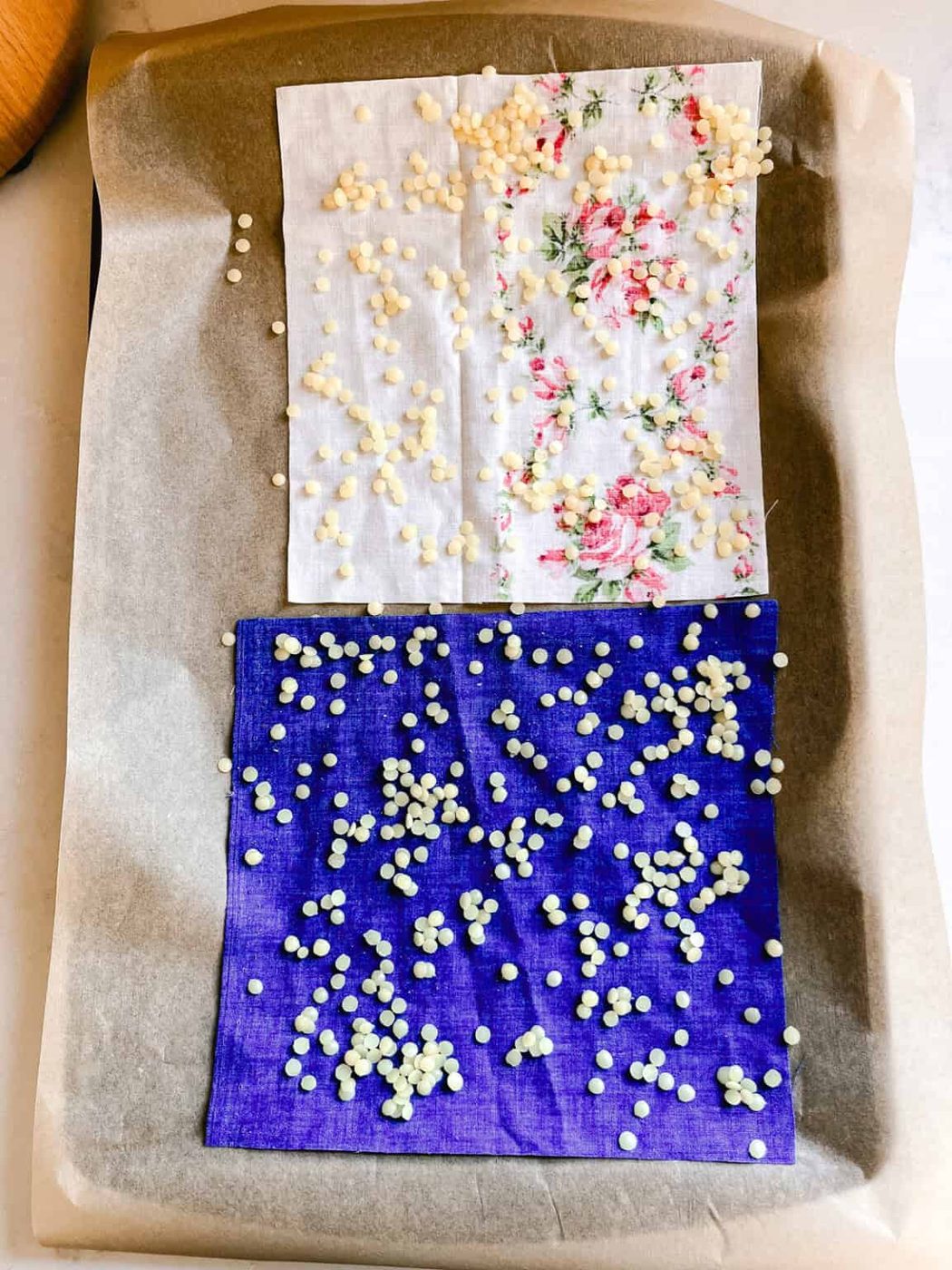 Beeswax pellets scattered over the fabric squares.