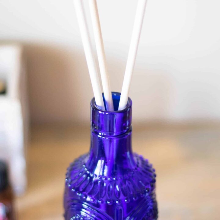 A homemade reed diffuser using a blue vase.