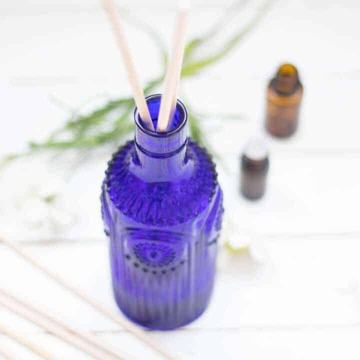 blue with vase with reeds on white ship lap