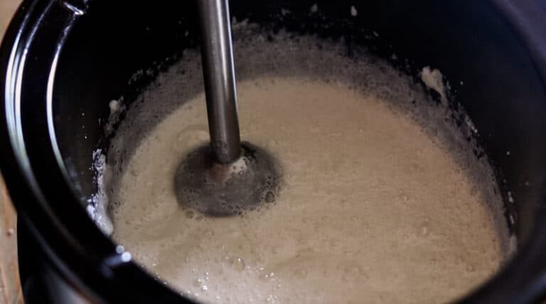 Bring oils to trace using a immersion blender for making soap.