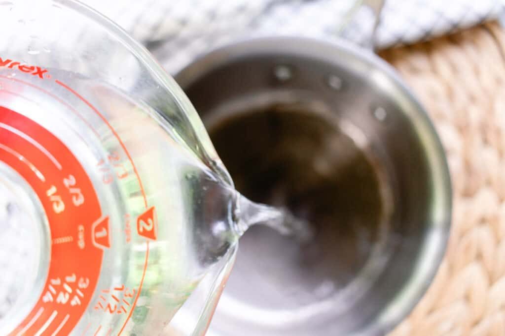 Adding water to the pot.