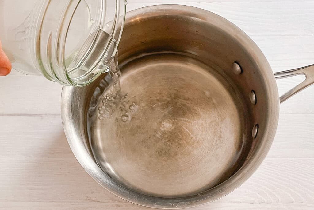 Filling a small sauce pan with water.