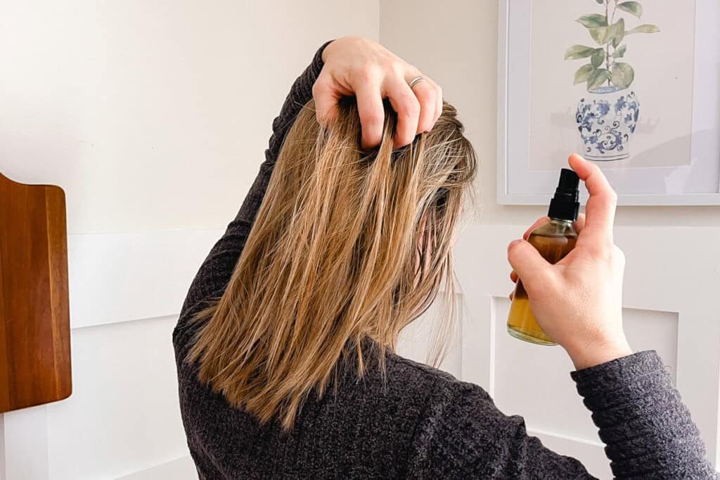 Spraying the rosemary water into the strands of our hair.