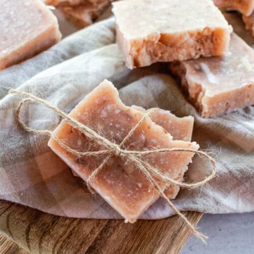 Rebatch soap bars on a linen towel with twine wrapped around them.