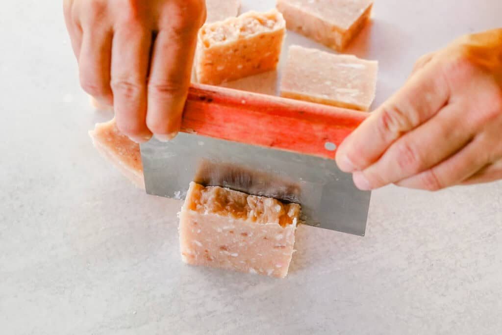Cutting the rebatch soap into individual bars.