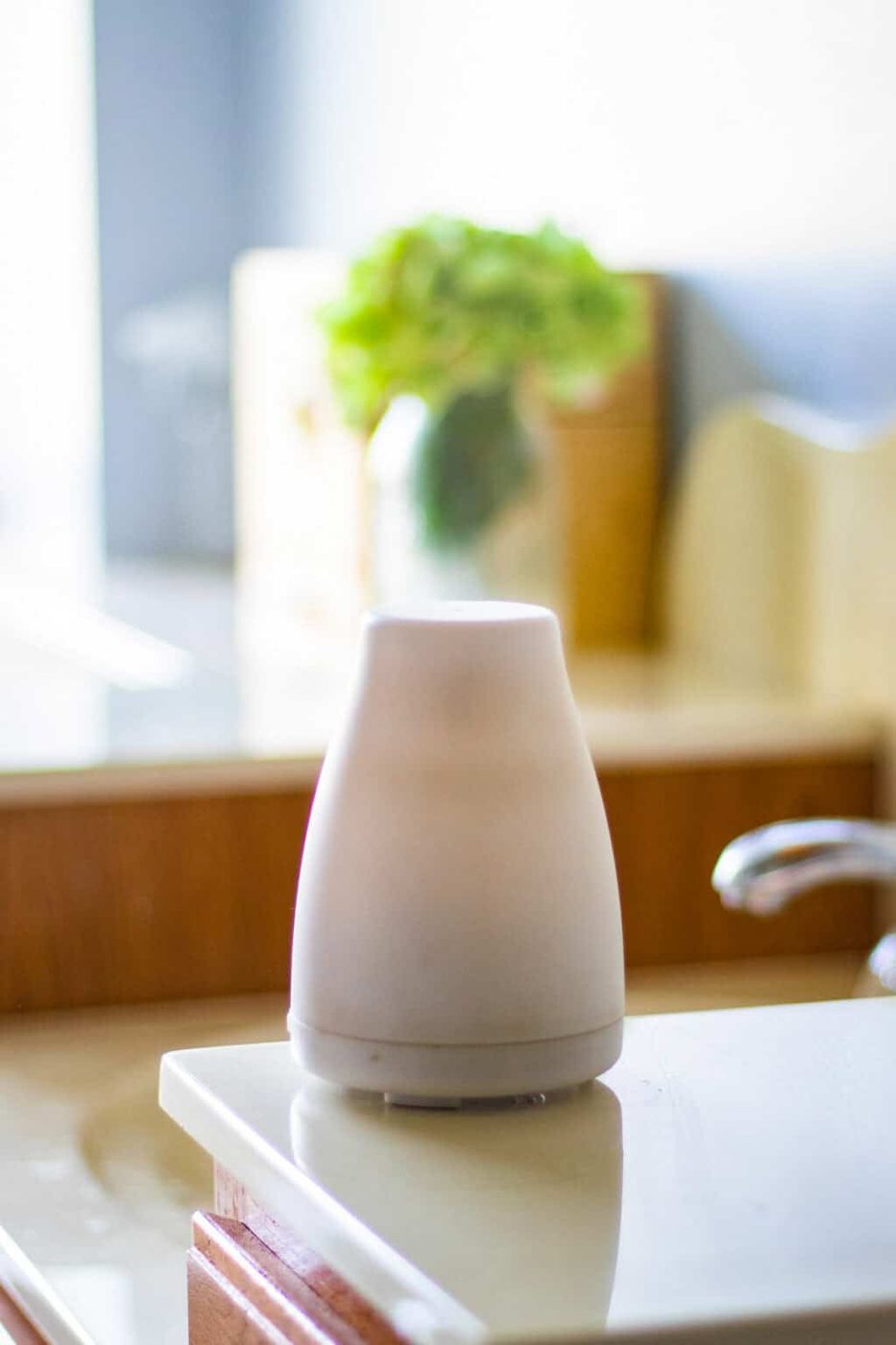 An essential oil diffuser on a kitchen counter.