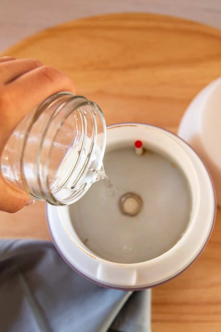 Pouring water into a diffuser.