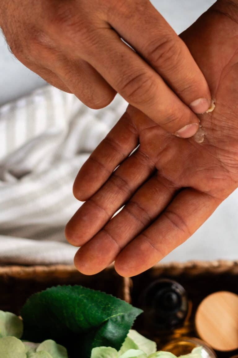 Smearing a touch of a beard balm onto our hands to melt before applying to the beard.