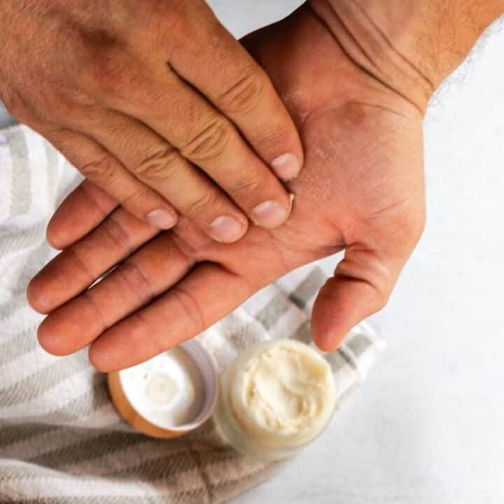 Applying beard balm to the palms of our hands.