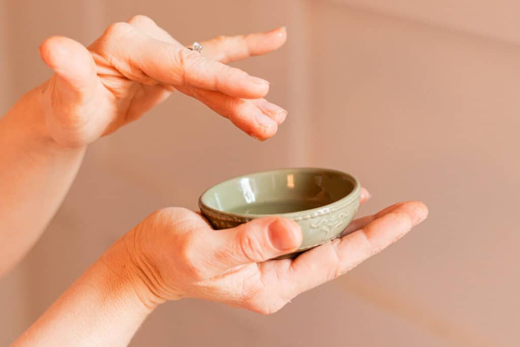 Getting a bit more of the castor oil onto our fingers for the hair.