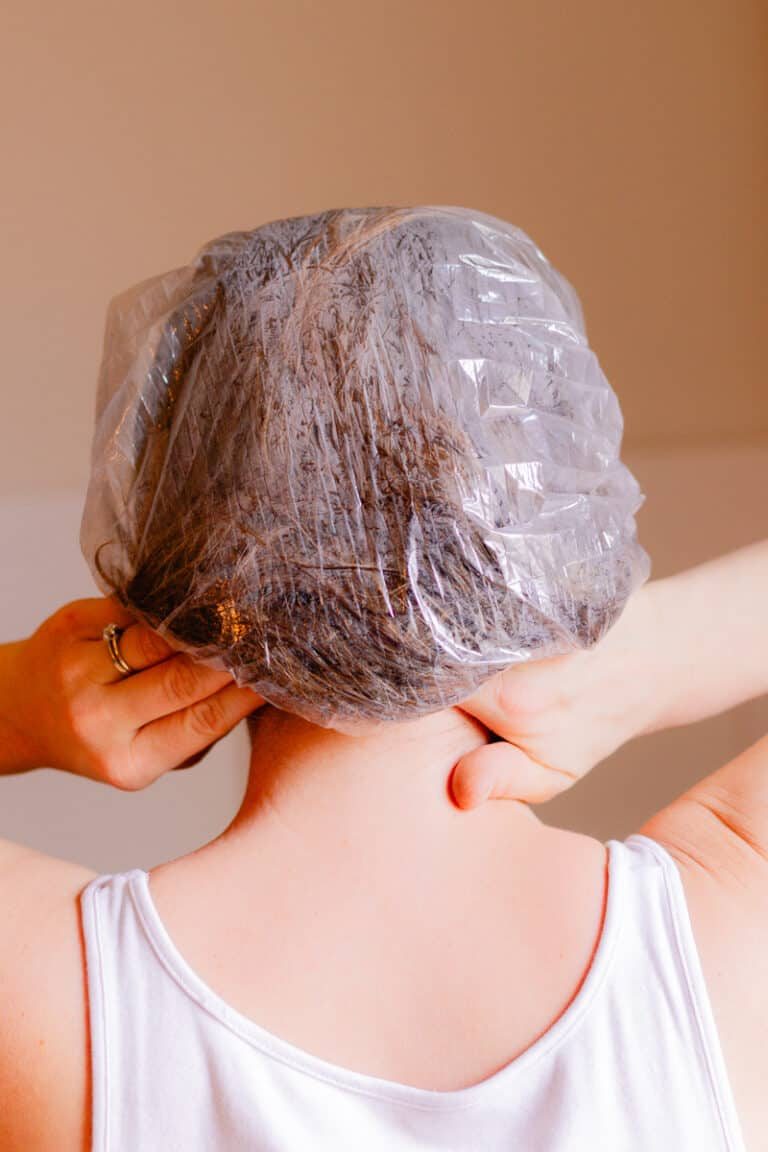 Putting a shower cap over our hair during hair oiling to keep the oils contained.