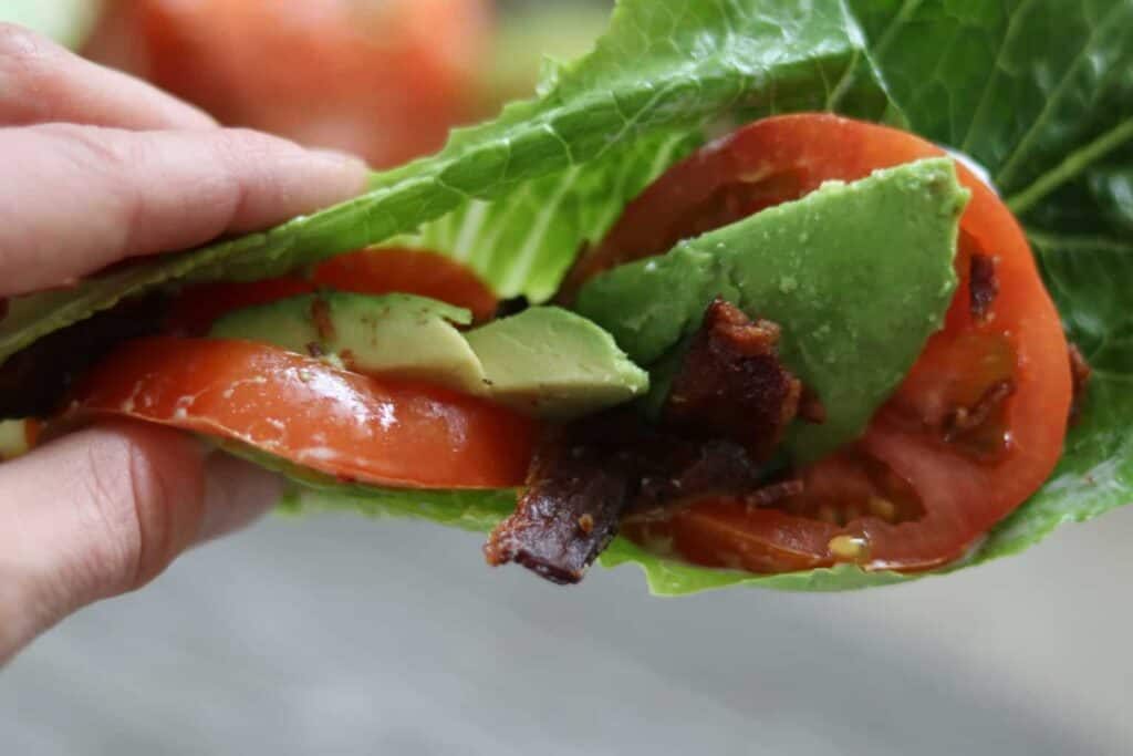 Tomatoes, avocado, and bacon rapped in lettuces.