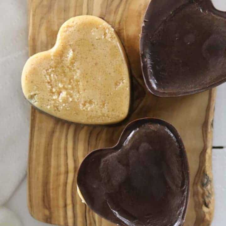 Peanut butter chocolate hearts on a wooden table.