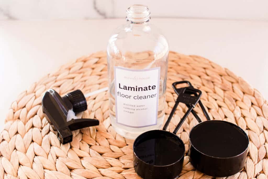Homemade laminate floor cleaner bottle and tools.