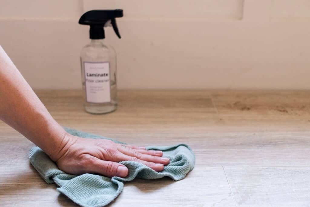 Cleaning laminate flooring with homemade laminate floor cleaner.