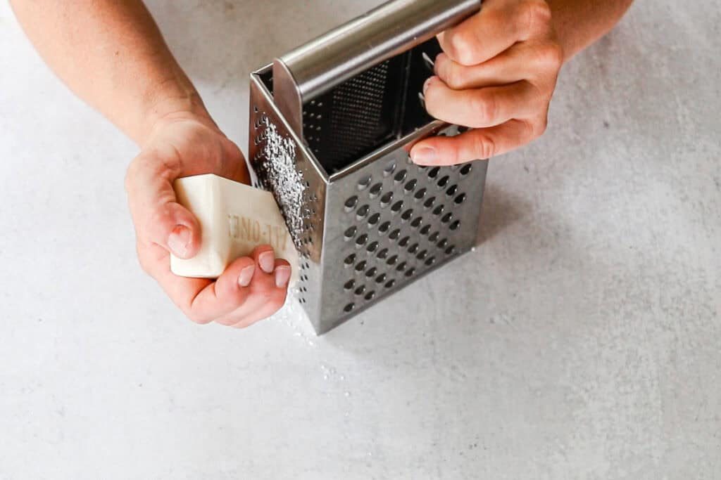 Grating a castile soap bar with a box grater.