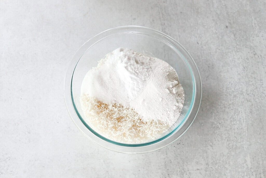 A glass bowl with the dry ingredients in it.