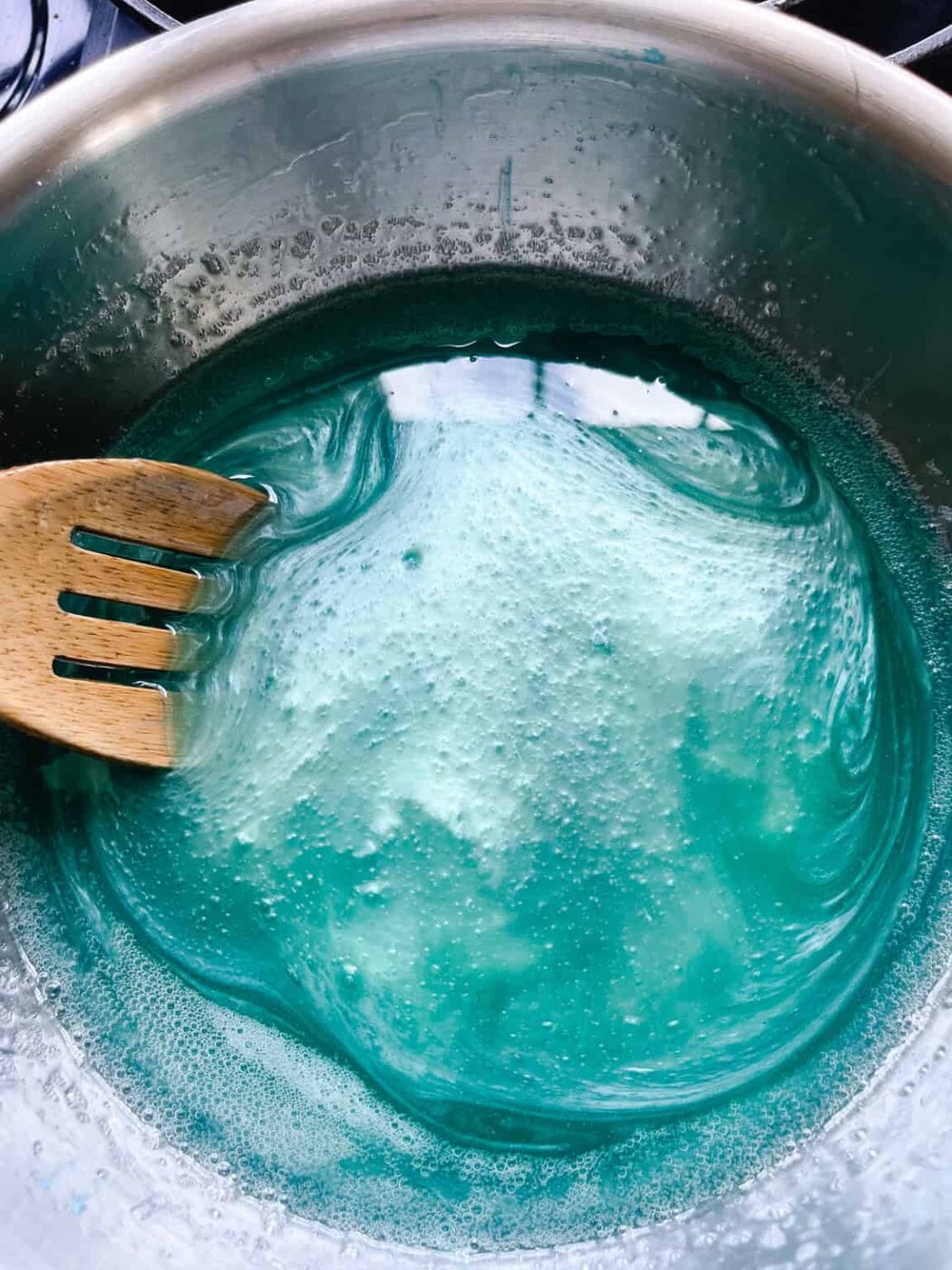 Stirring mica powder into melted soap base.