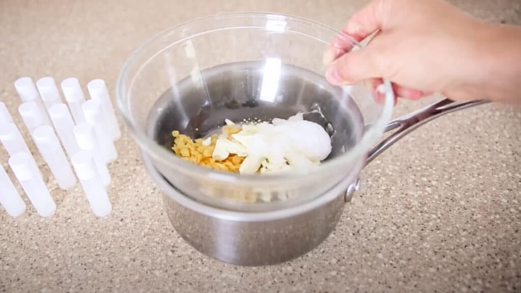 Adding the lip balm ingredients to the double boiler.