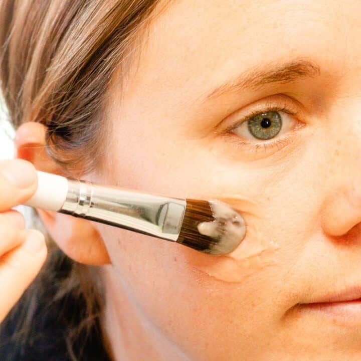 Applying our homemade liquid foundation to our cheeks.