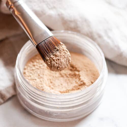 Dipping makeup brush into our homemade mineral makeup powder.