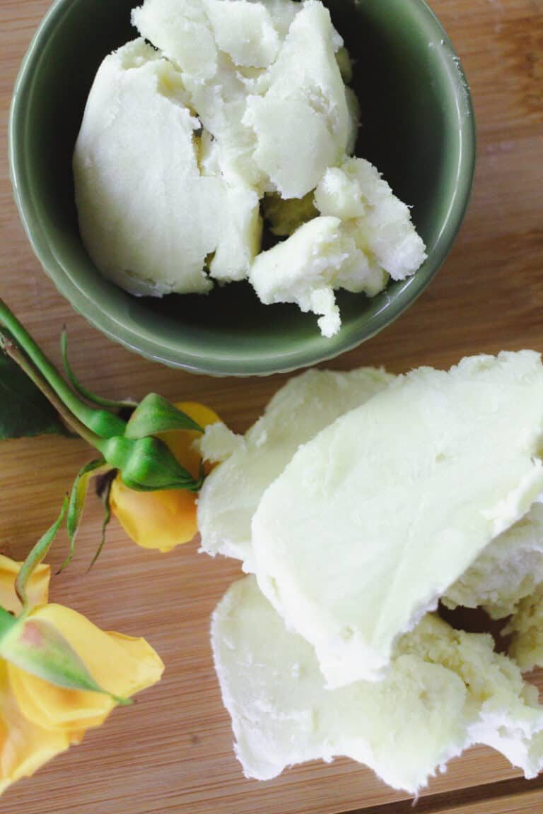 Mango and shea butter on a wooden board.