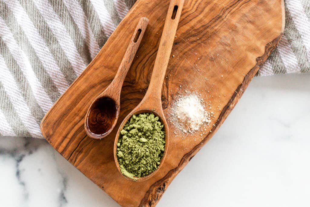Matcha powder and oil on a wooden board.