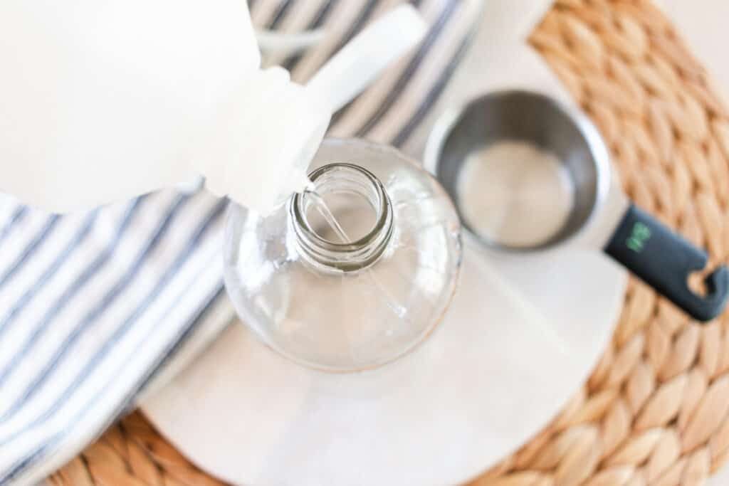 Adding rubbing alcohol to a glass bottle.