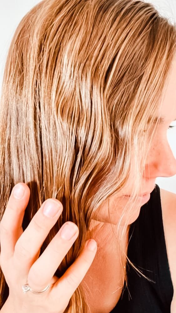 Using curl enhancing cream on the hair.