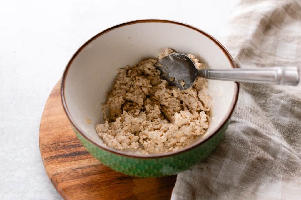 Oatmeal and yogurt face mask all mixed together in a green bowl.