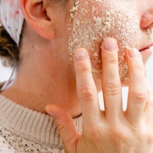 Applying oatmeal face mask to our face.