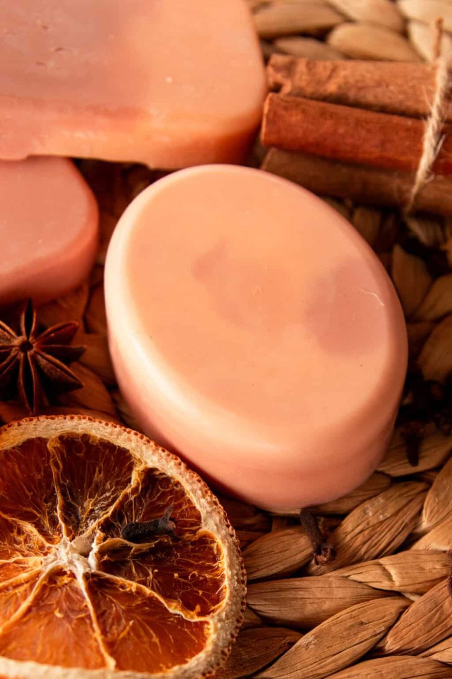 An oval-shaped orange creamsicle soap bar with dried orange slices.
