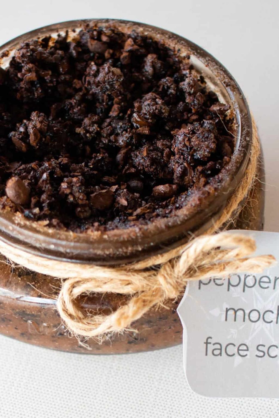 Peppermint face scrub with ground coffee in a decorative jar with hemp string tied around it with a beautiful label.