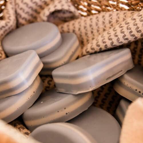 A basket full of peppermint layered soap bars.