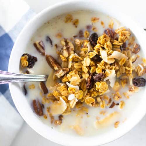 A bowl of homemade pumpkin granola with milk.